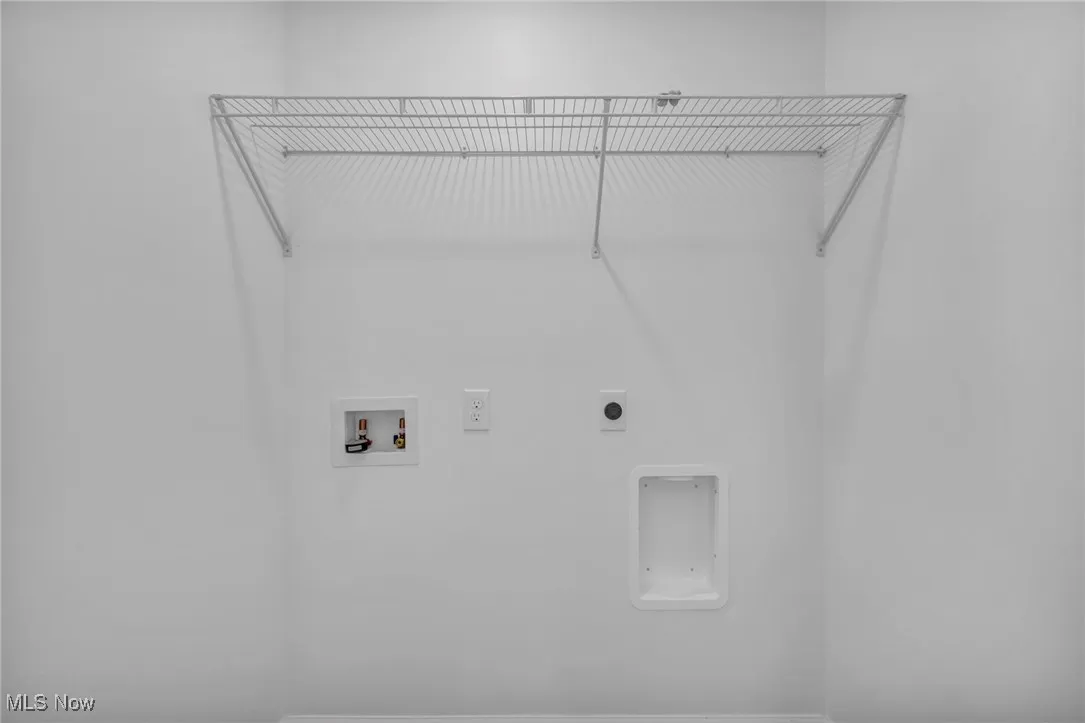 Washroom with hookup for a washing machine and hookup for an electric dryer