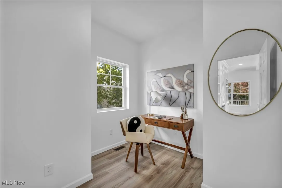 Office area with plenty of natural light and light wood-style flooring