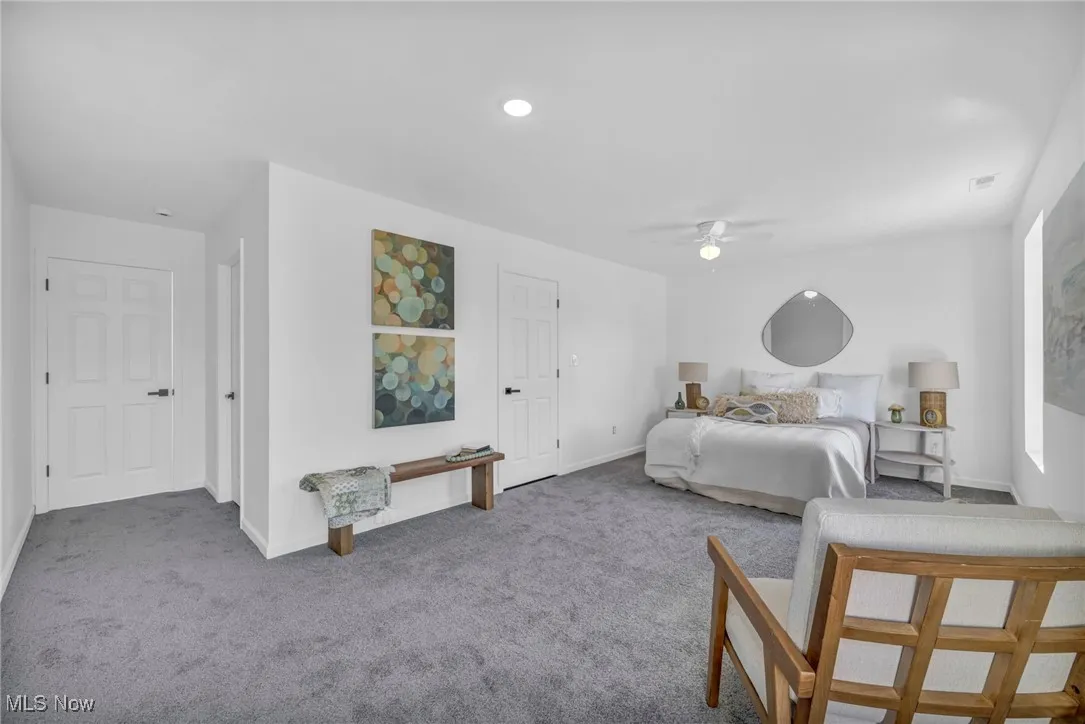Carpeted bedroom with baseboards and a ceiling fan