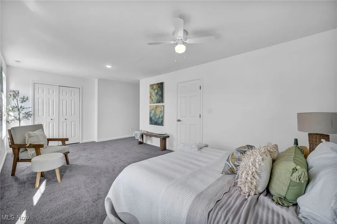 Bedroom with carpet floors, a closet, and a ceiling fan