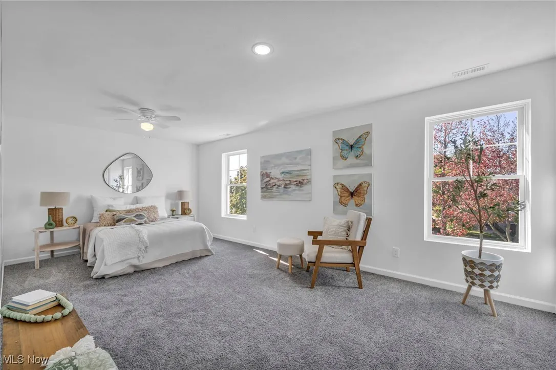 Carpeted bedroom featuring ceiling fan and recessed lighting