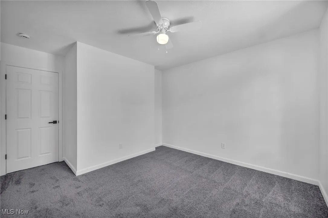 Unfurnished bedroom featuring carpet floors and ceiling fan