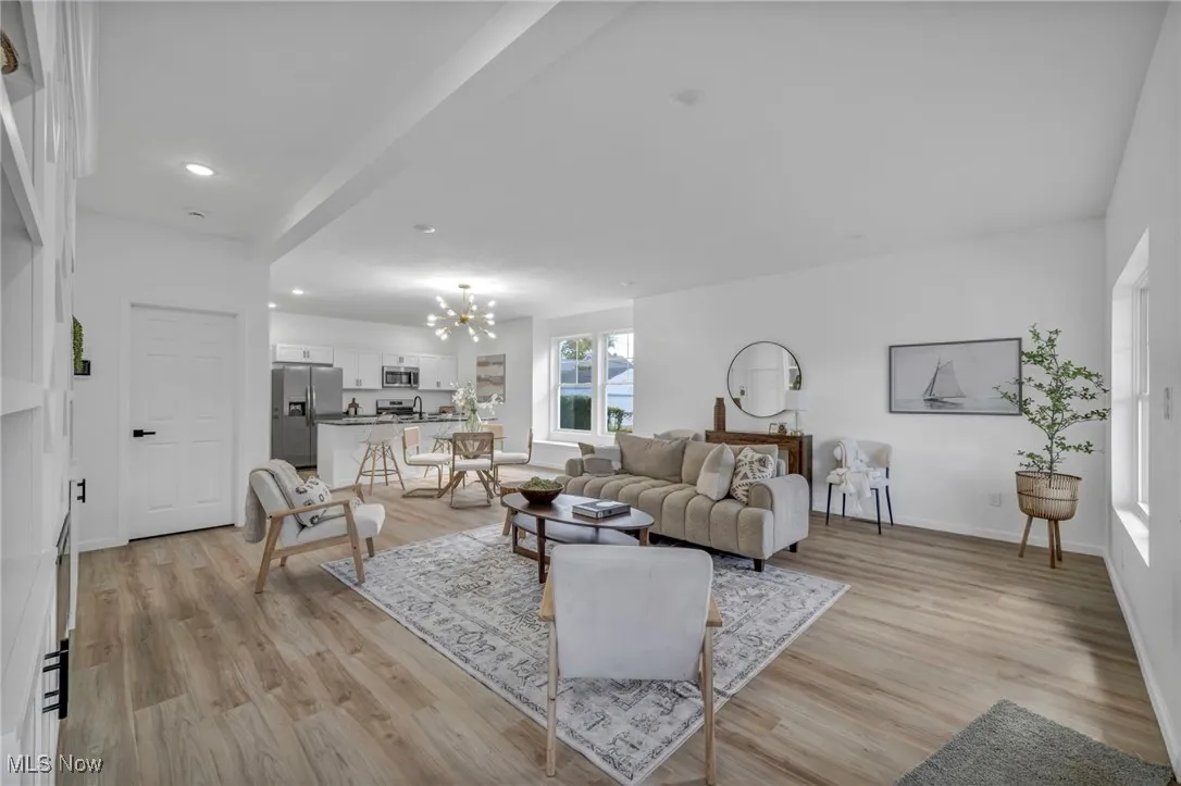Living area featuring a chandelier, light wood finished floors, and recessed lighting