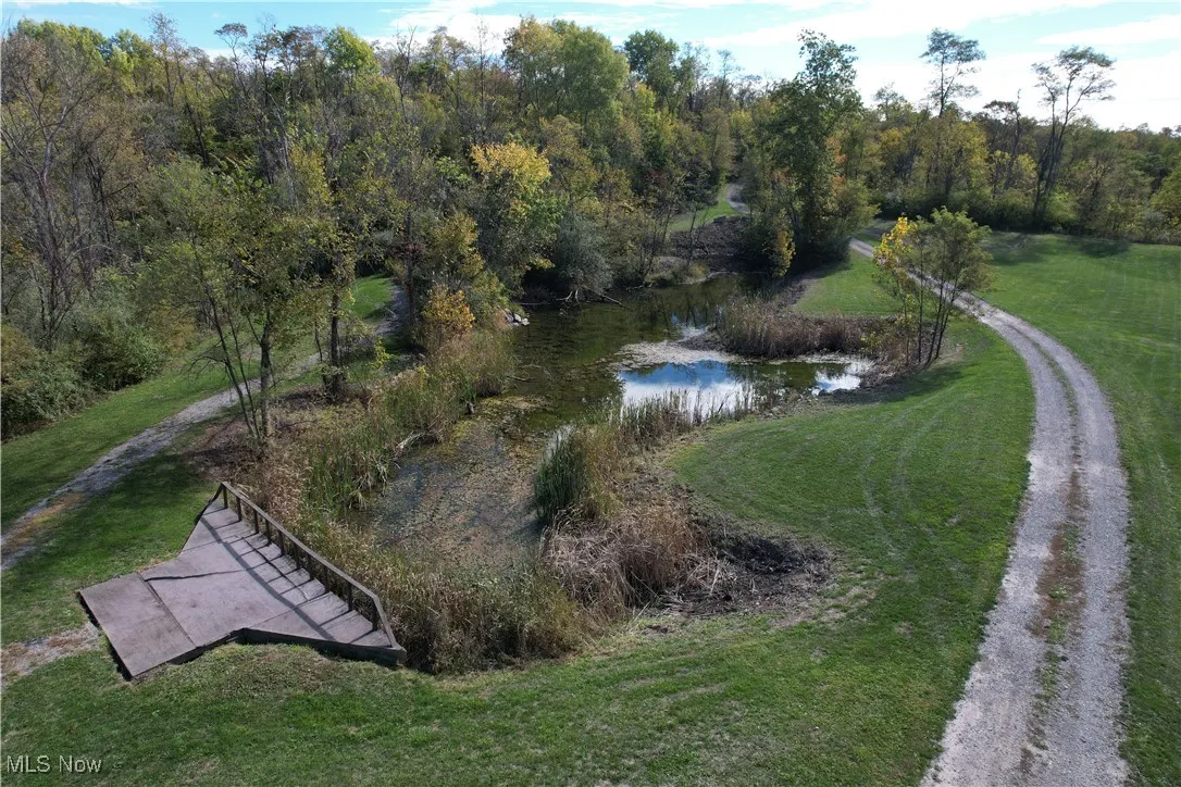 Aerial view of property's location with a large body of water