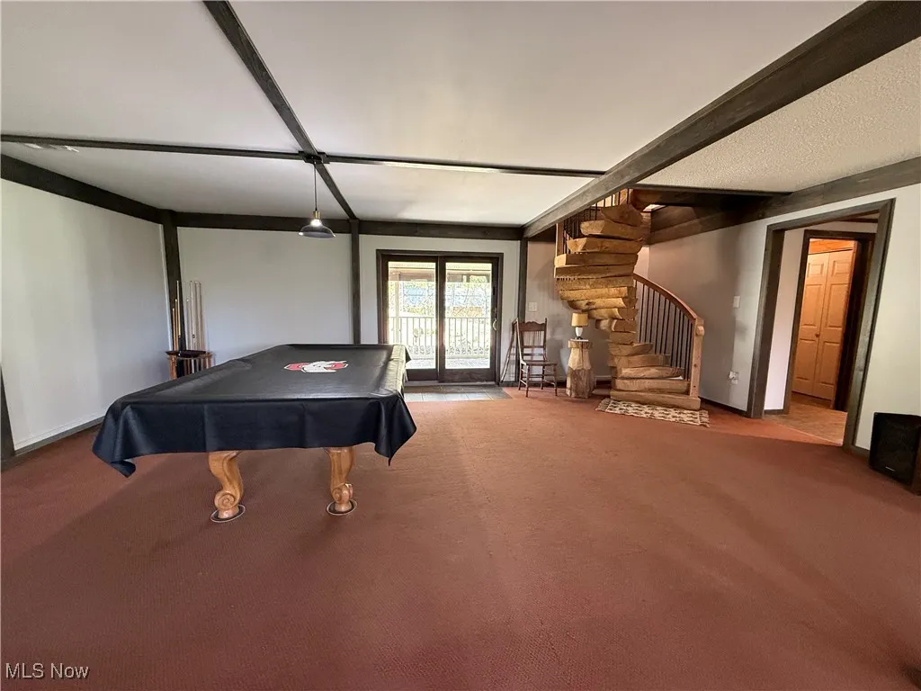 Playroom featuring carpet floors, pool table, and beamed ceiling