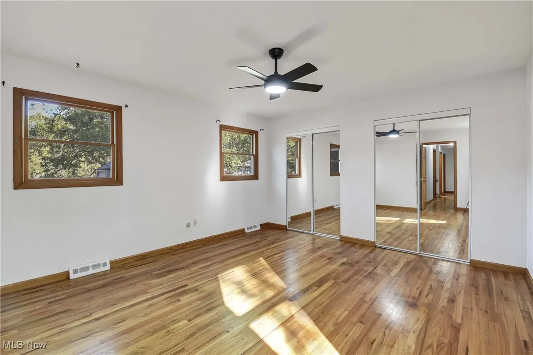 Large bedroom #5 with 2 closets and hardwood flooring.