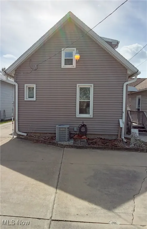 View of back of property with a central AC unit
