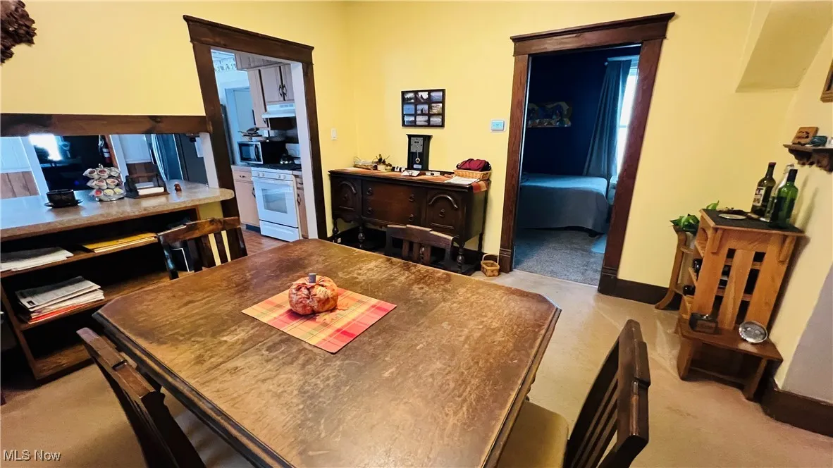 Dining room featuring light carpet and dark woodwork