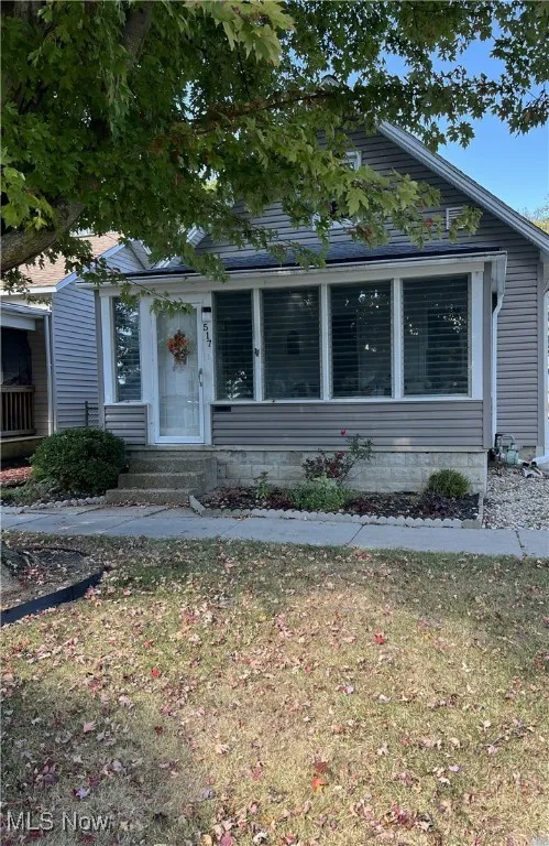 Bungalow-style house featuring entry steps and enclosed front porch.