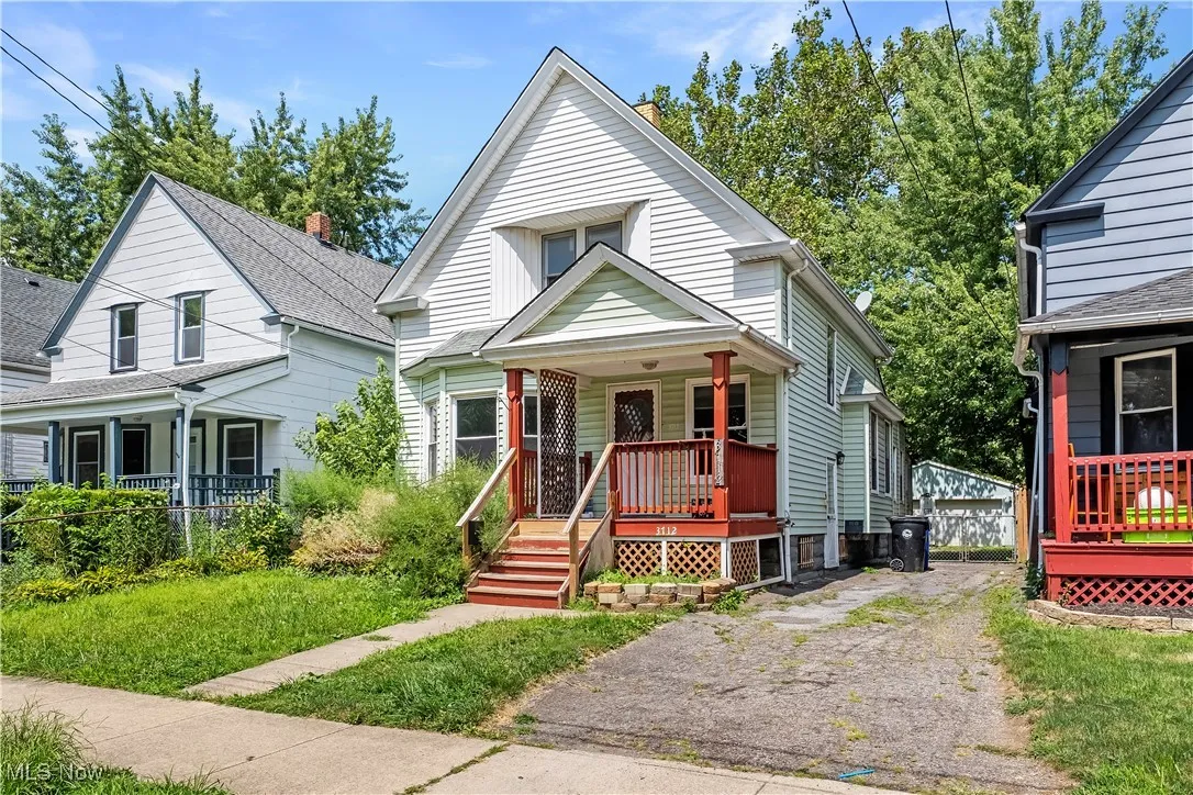Bungalow-style house featuring covered porch and a front lawn