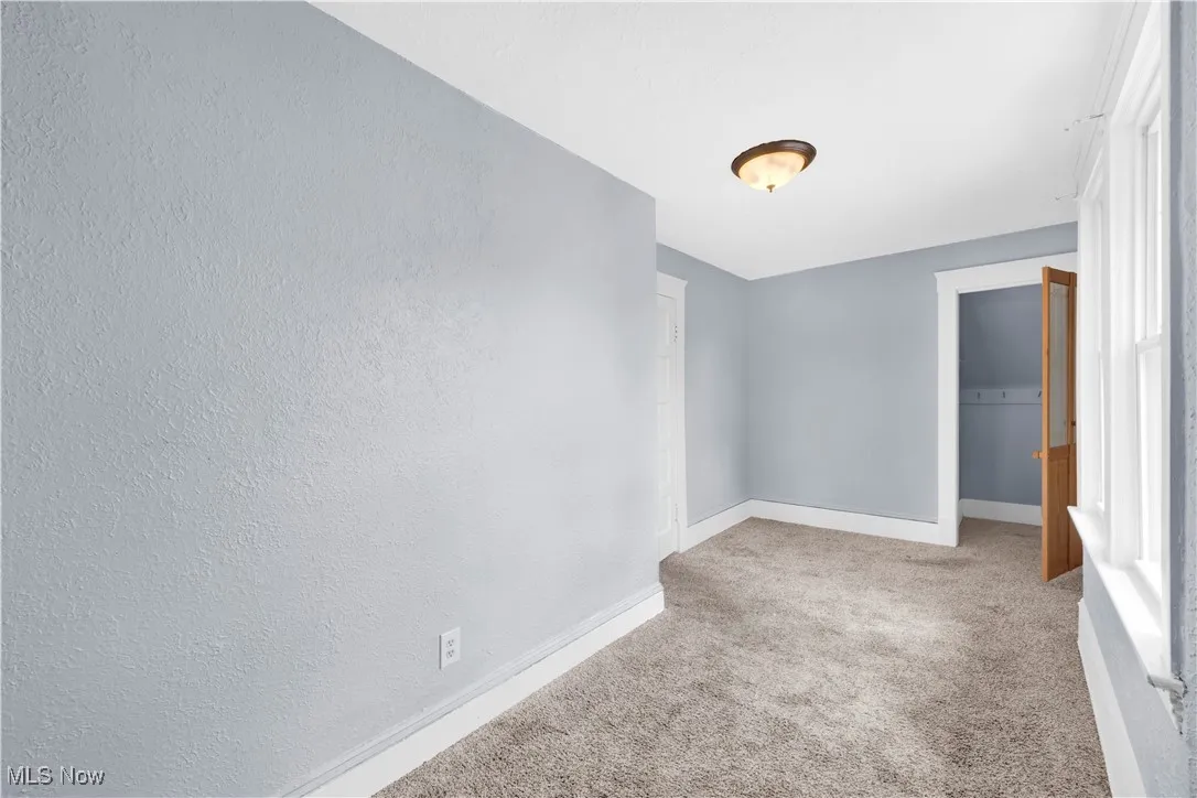 Spare room with baseboards and carpet flooring