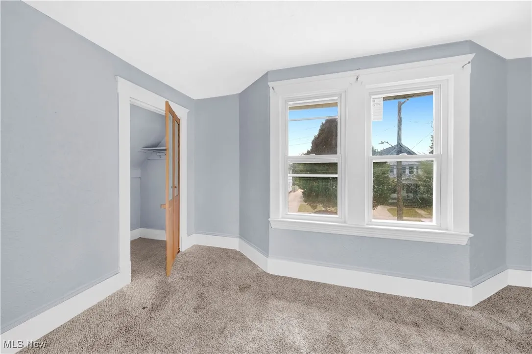 Bonus room with carpet floors and vaulted ceiling