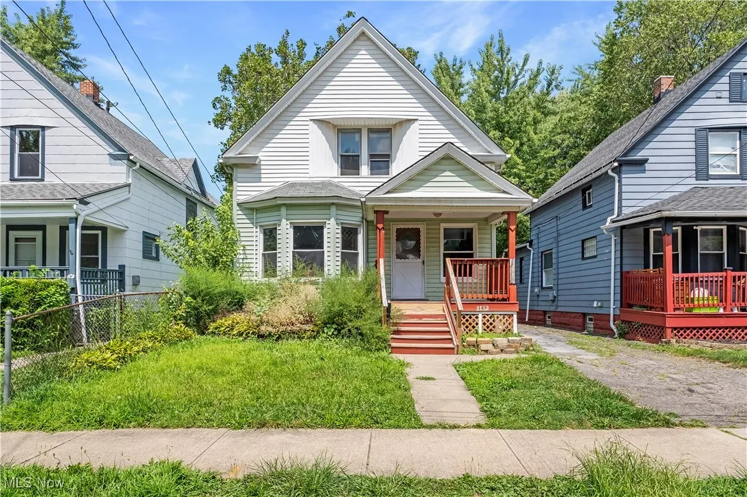 View of front of home with a porch and a front yard