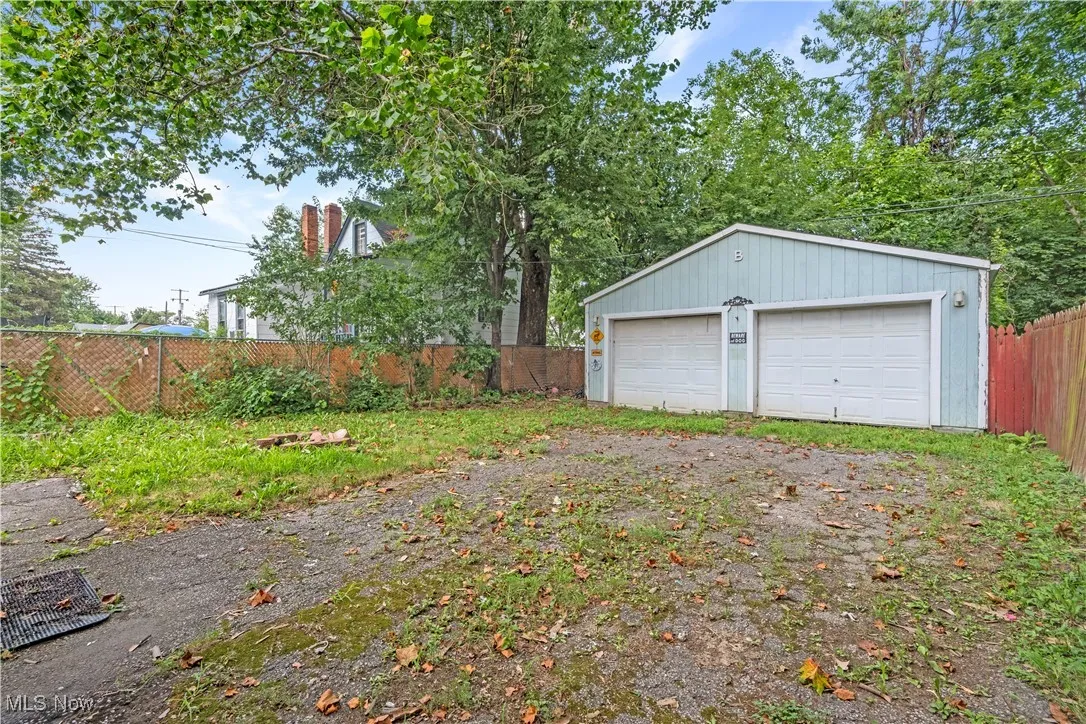 View of yard with an outbuilding and a garage