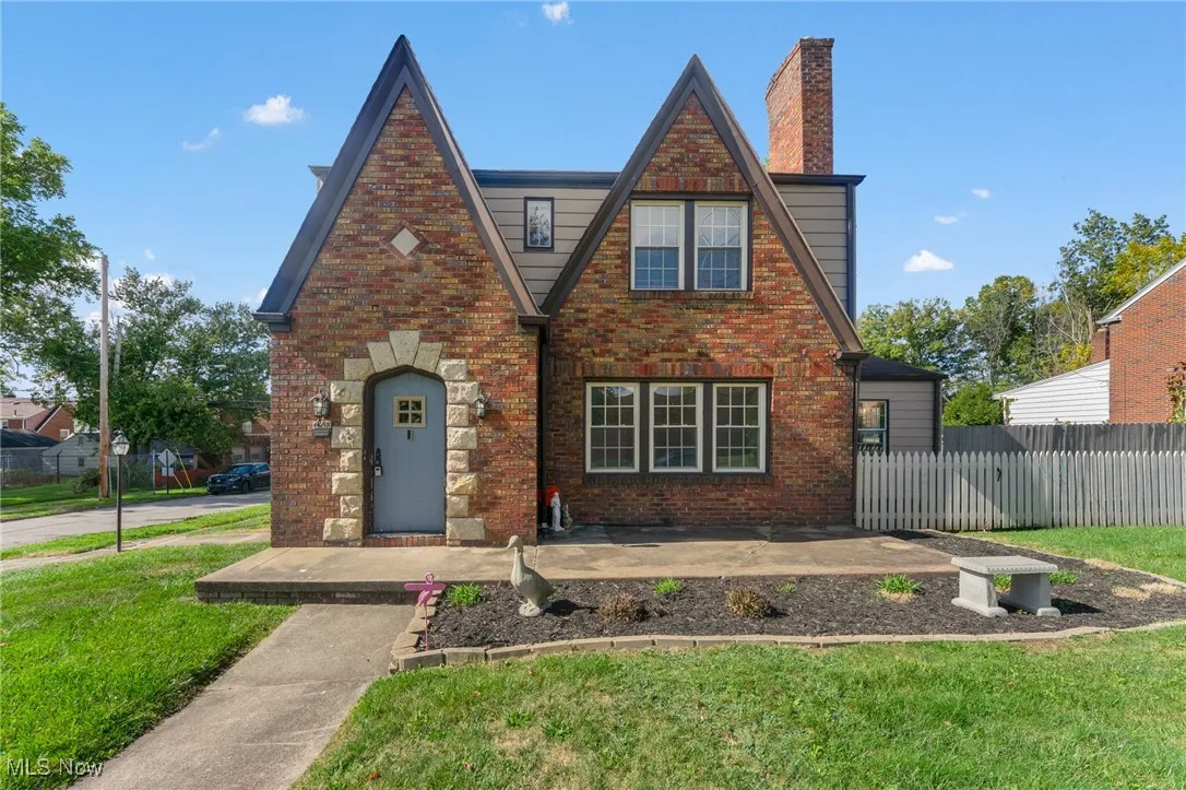 Tudor-style house with brick siding and a chimney