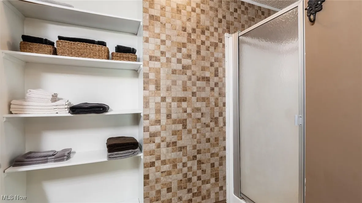 Full bathroom featuring a stall shower