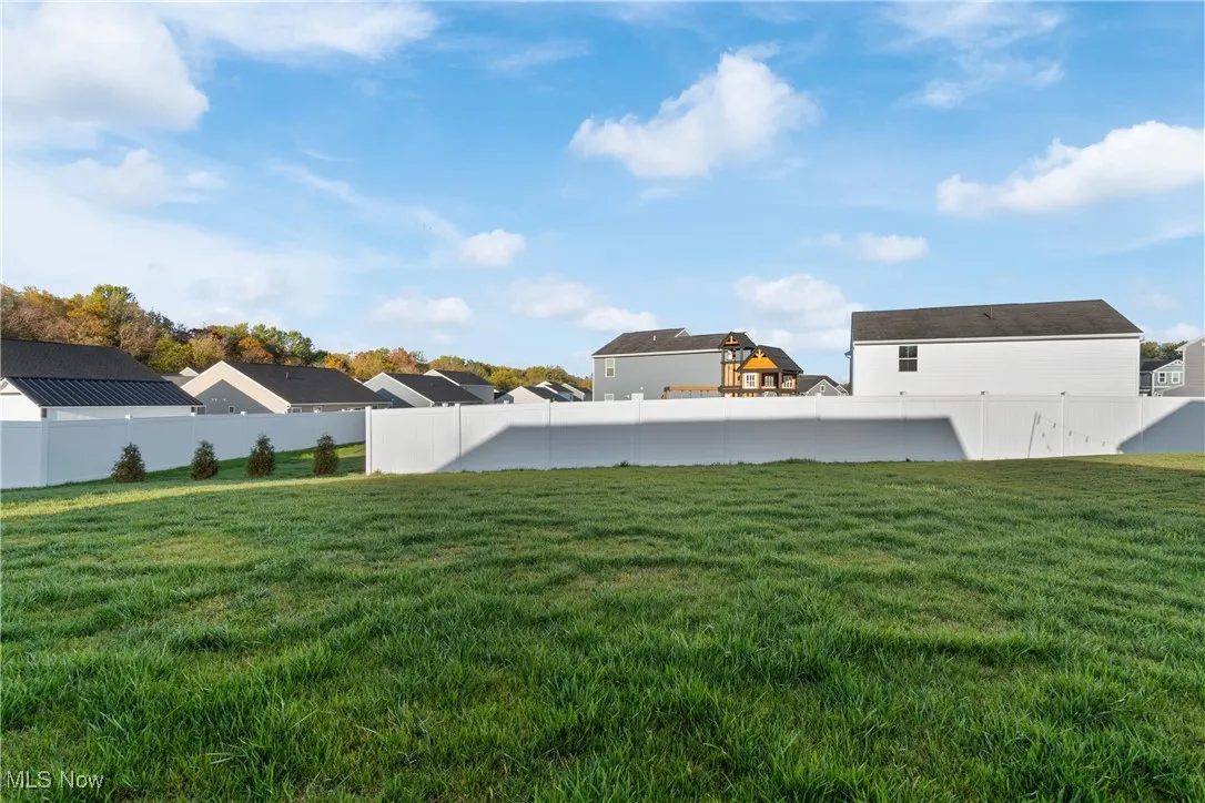 Fenced backyard with a residential view