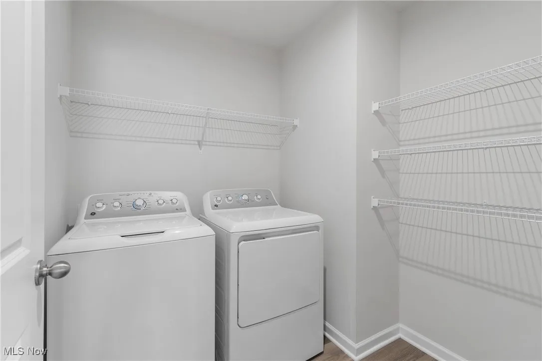 Laundry room featuring wood finished floors and independent washer and dryer