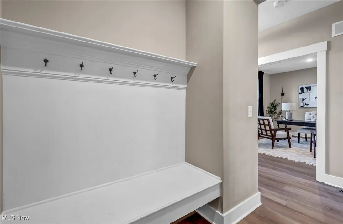 Mudroom featuring baseboards and wood finished floors