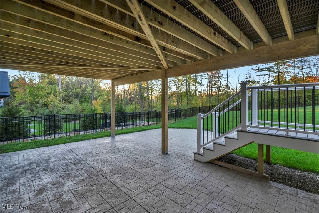 Fenced backyard with a patio and stairs