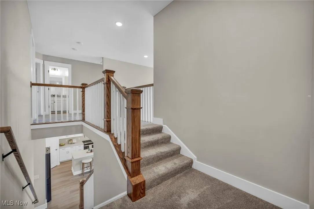 Staircase featuring recessed lighting and carpet