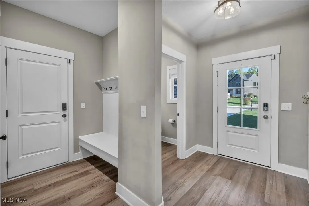 Mudroom with baseboards and light wood-type flooring