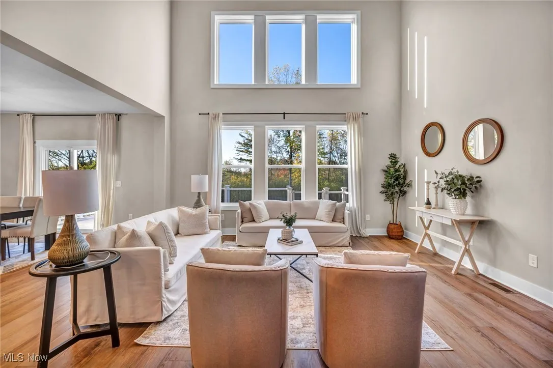 Living room with a towering ceiling and wood finished floors