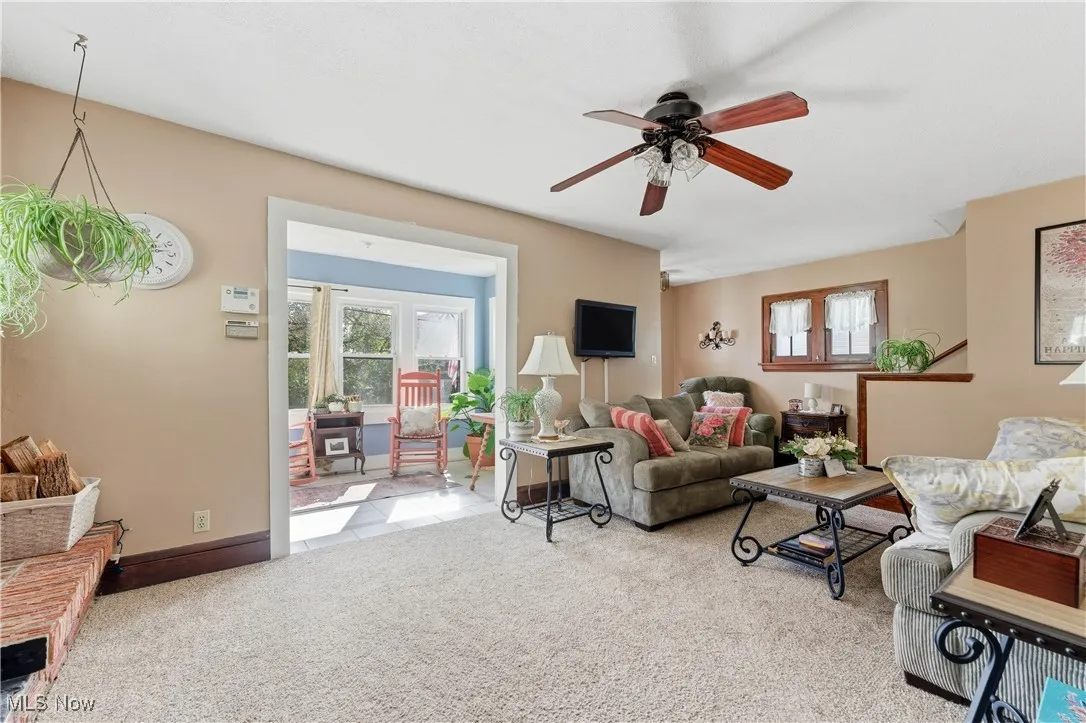 Living room with light carpet and ceiling fan
