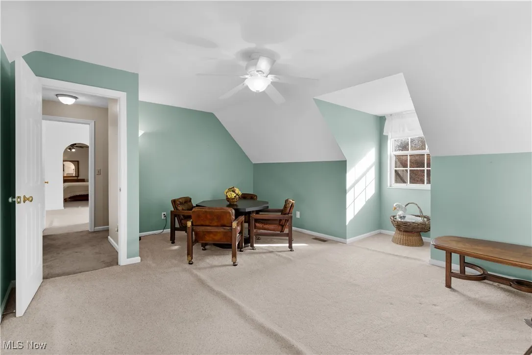 Bedroom #2 with carpet, ceiling fan, lofted ceiling, and arched walkways