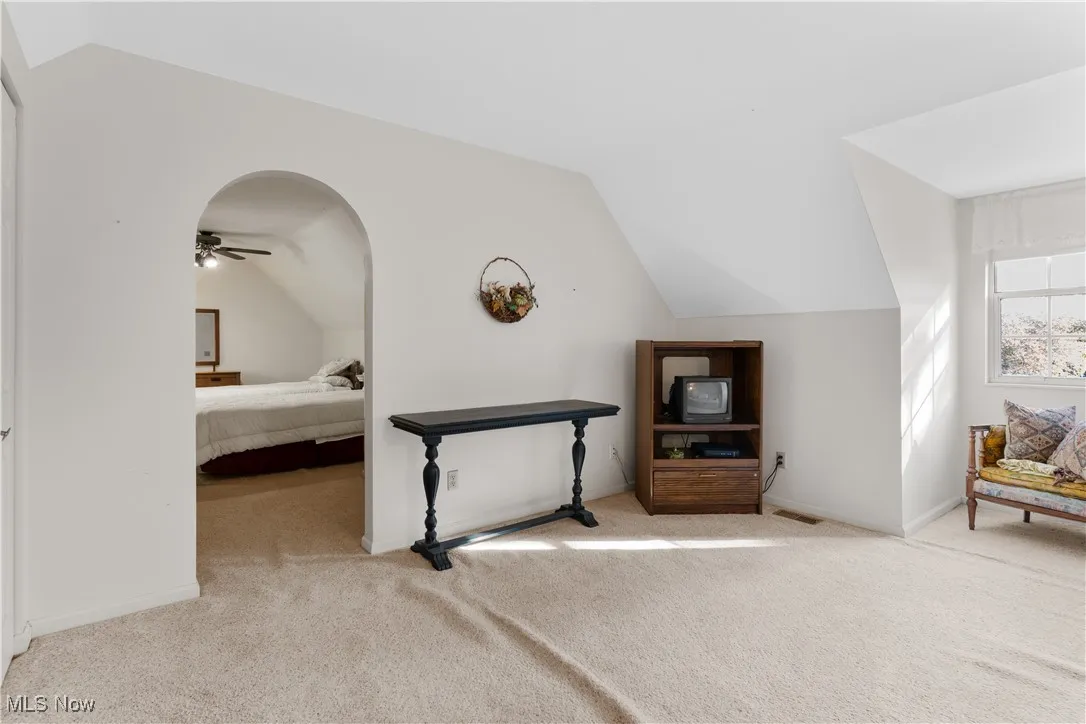 Bedroom #3 featuring lofted ceiling and light colored carpet