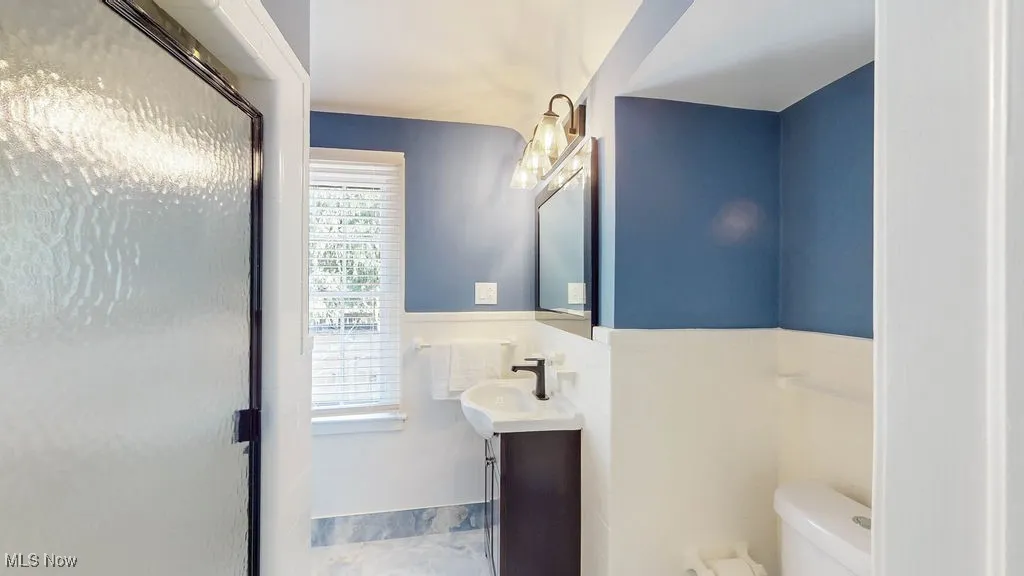 Bathroom featuring vanity and a shower with shower door