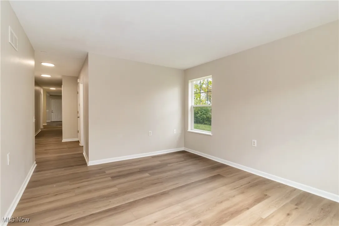 Unfurnished room with light wood-style flooring and recessed lighting