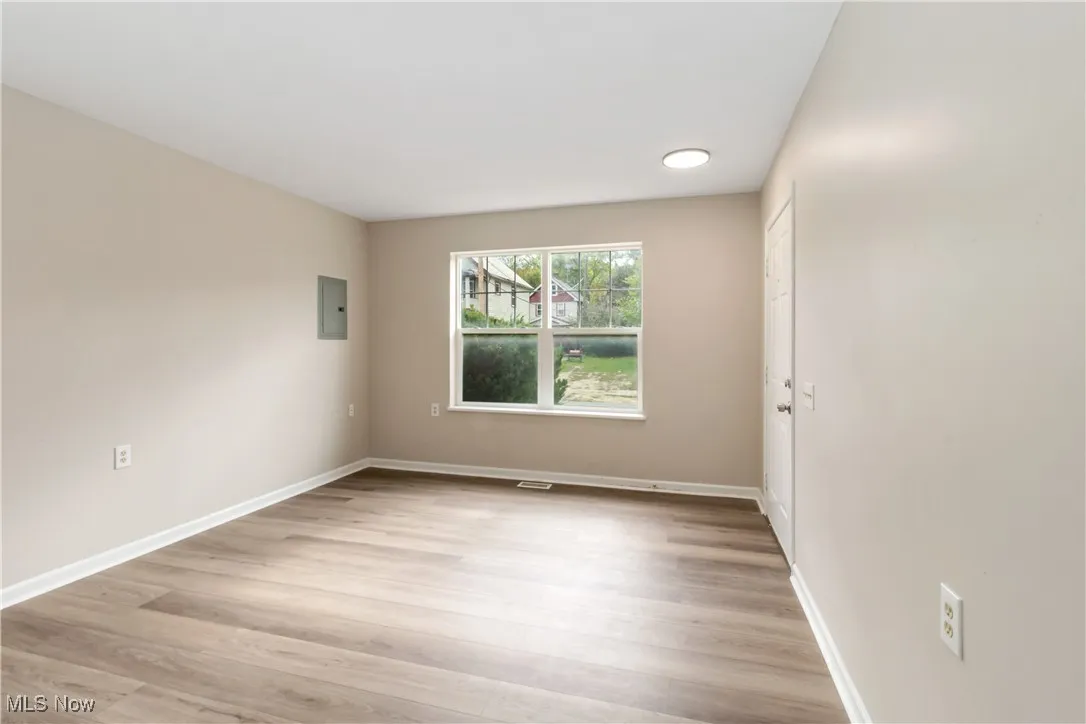 Spare room featuring light wood-style floors and electric panel