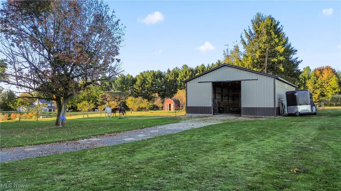 View of pole building with a lawn