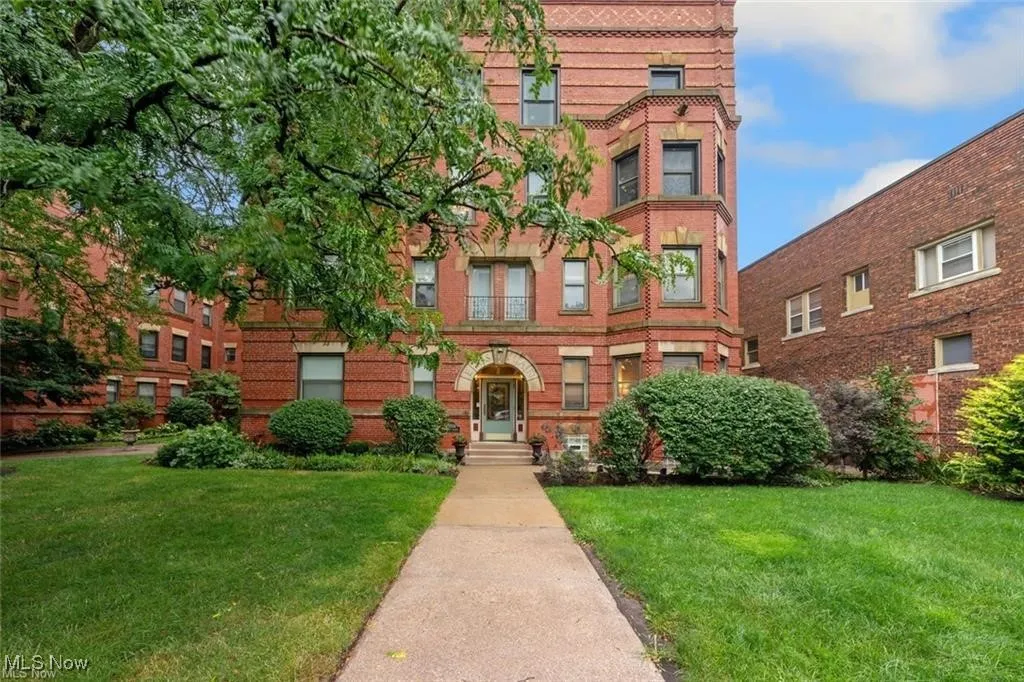 View of front of property with a front yard and brick siding