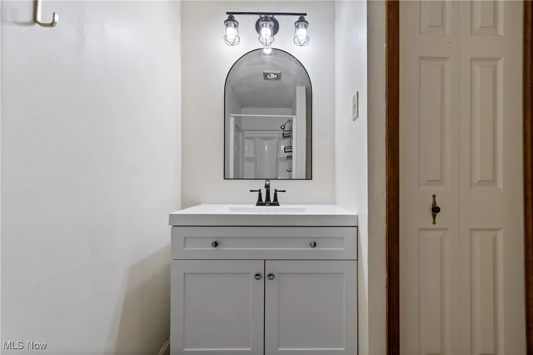 Full bath with vanity and a closet