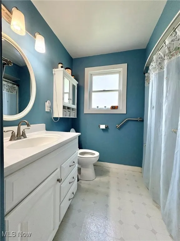 Bathroom featuring vanity and light floors