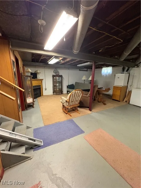 Unfinished below grade area featuring a fireplace