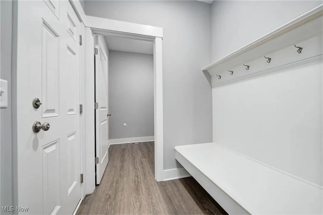 Mudroom with wood finished floors and baseboards