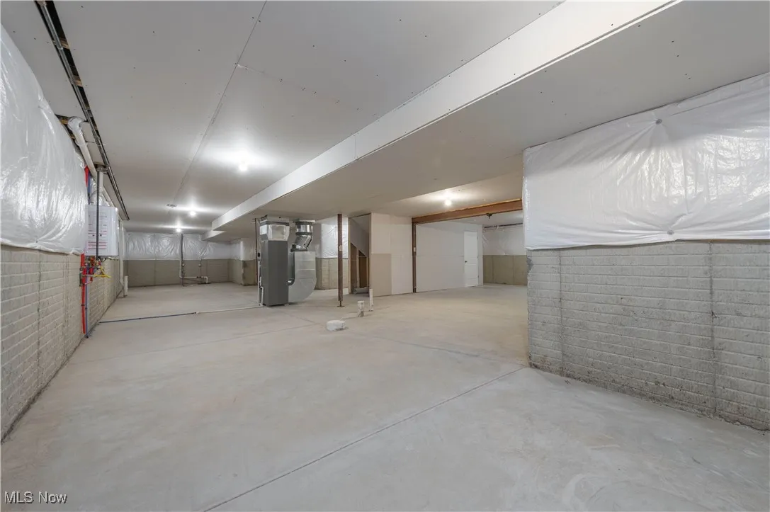 Unfinished basement featuring heating unit