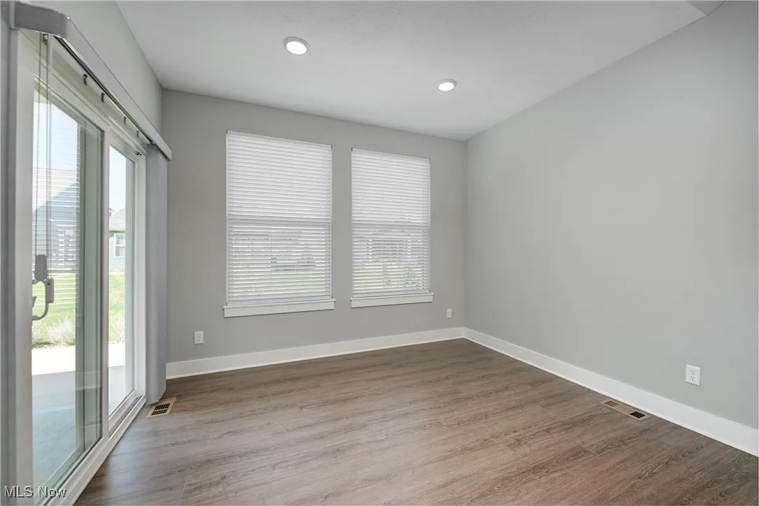 Spare room with dark wood finished floors and recessed lighting