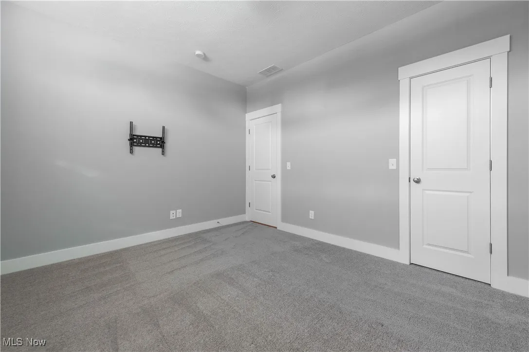 Unfurnished bedroom featuring carpet and baseboards