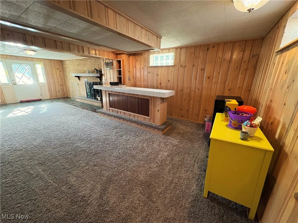 Recreation room with carpet and indoor bar