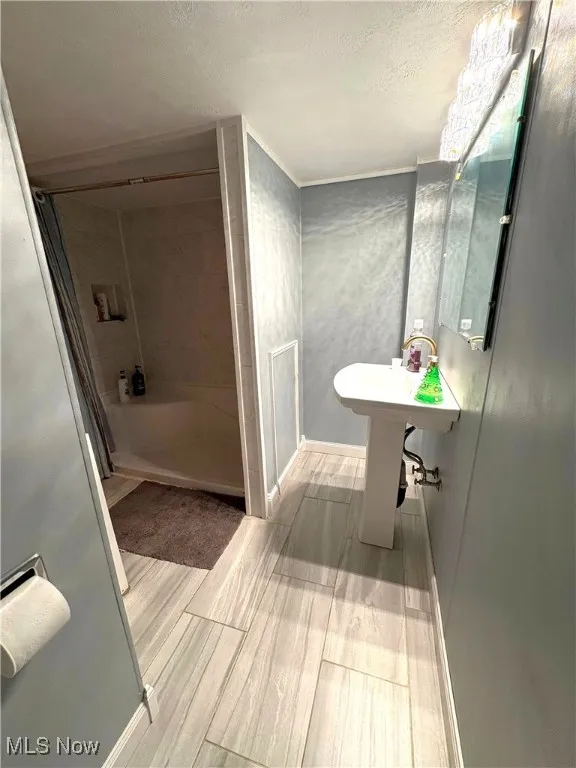 Bathroom featuring a shower and sink