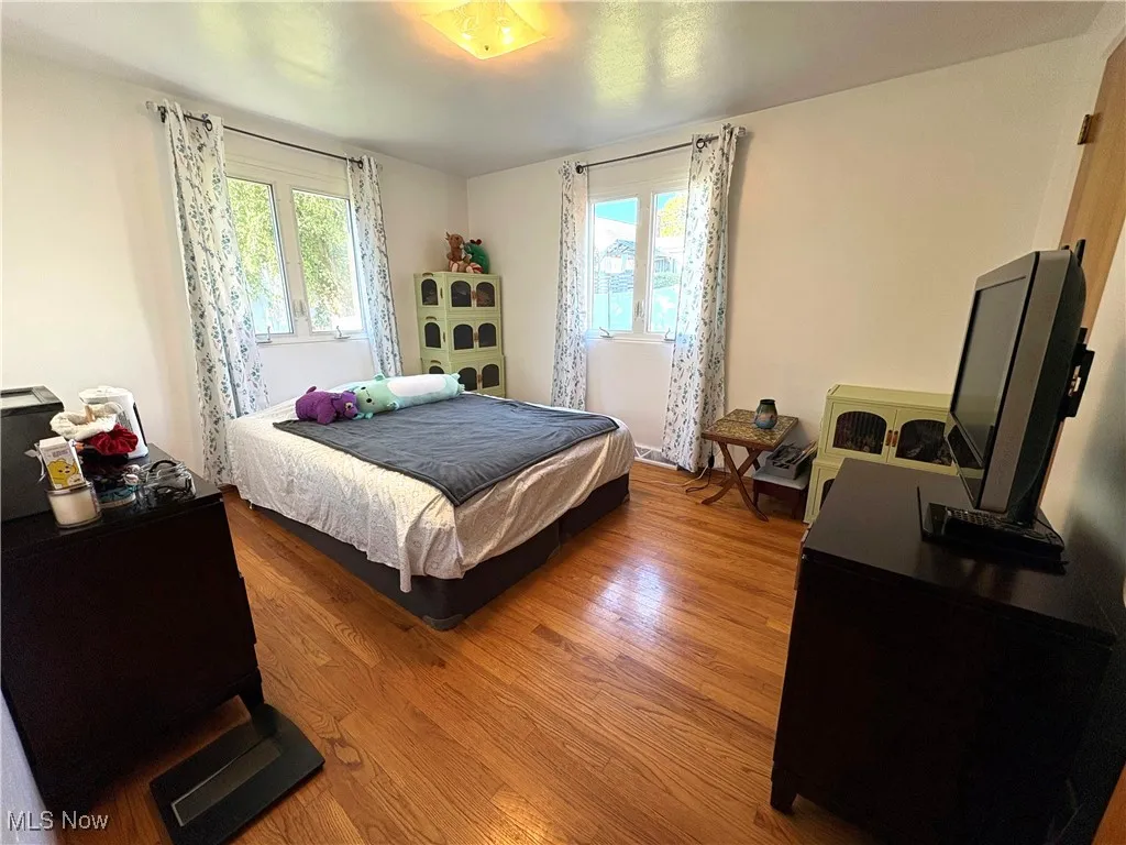 Bedroom with hardwood flooring