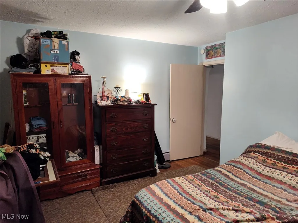 Bedroom featuring a textured ceiling and a ceiling fan