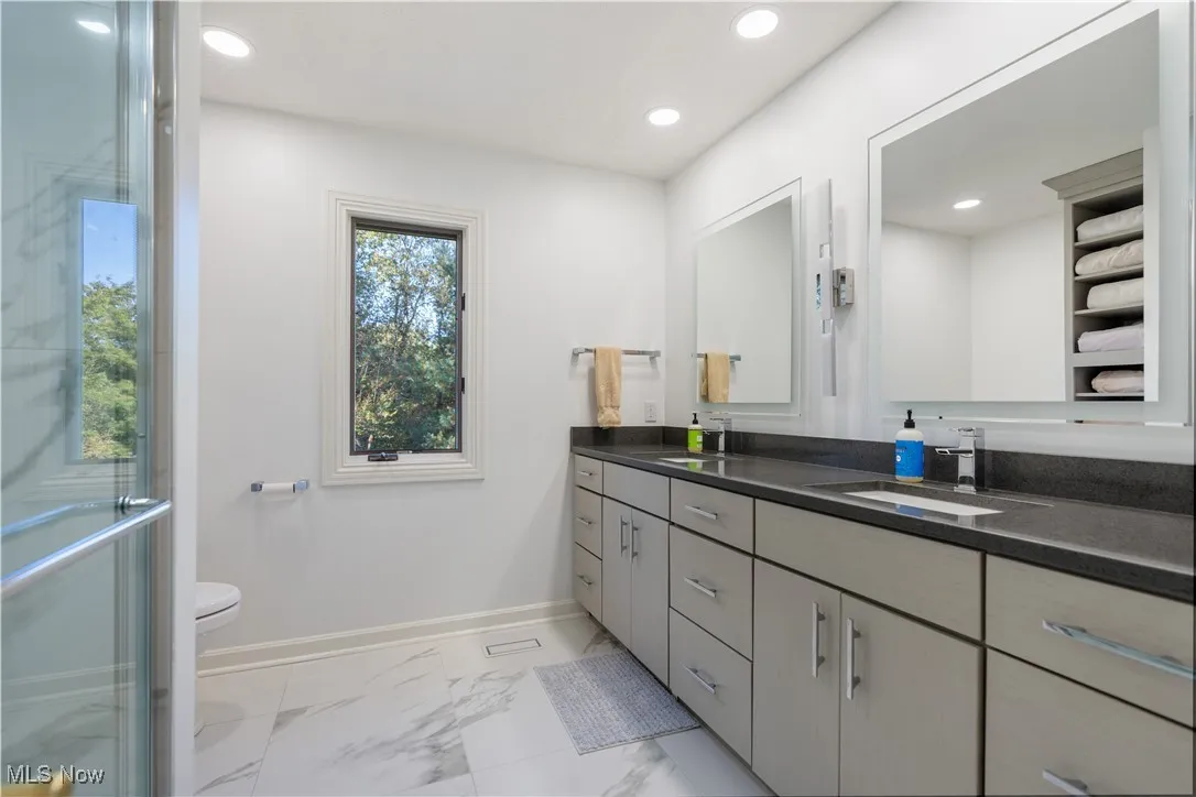 Full bathroom on the second floor with a double vanity, and walk- in shower.