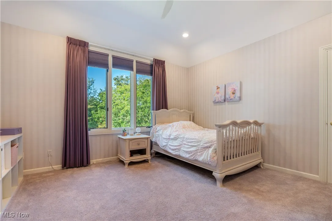 Bedroom 4 of 5 featuring light wallpapered walls and a lovely window.