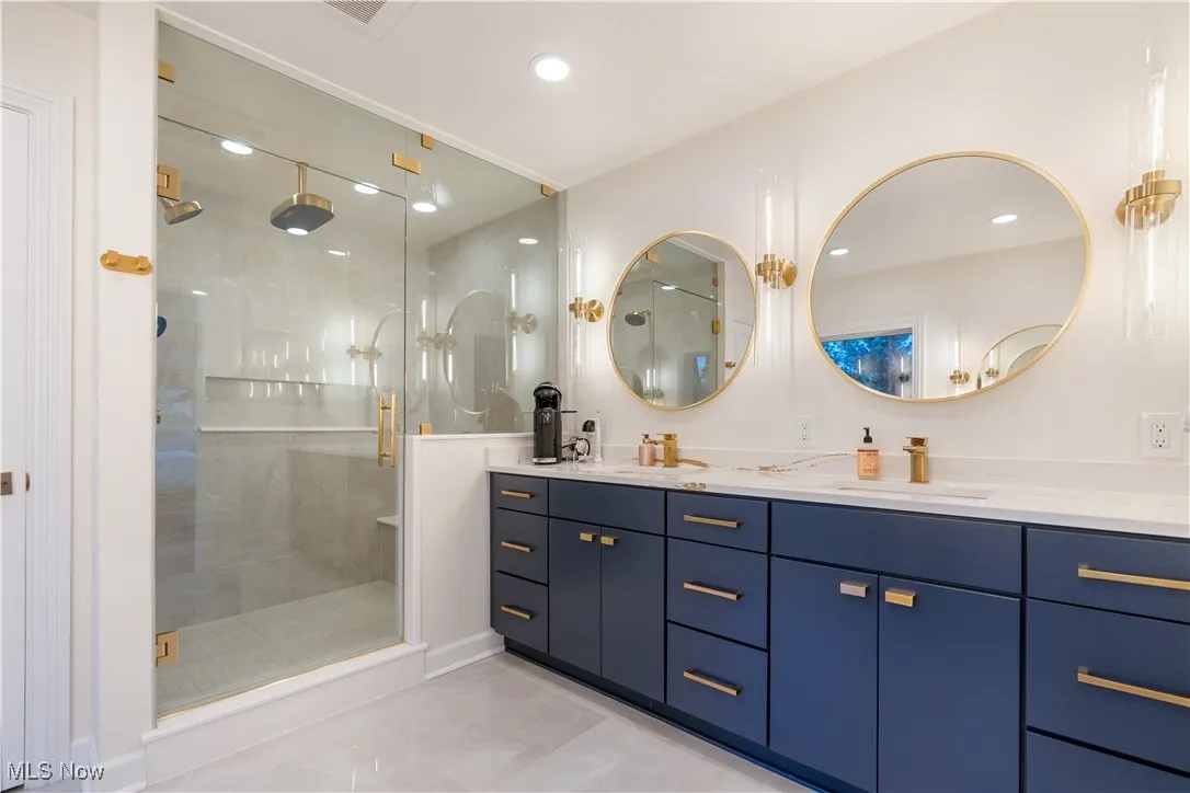 Master bathroom with a walk-in rainfall shower, and double vanity.