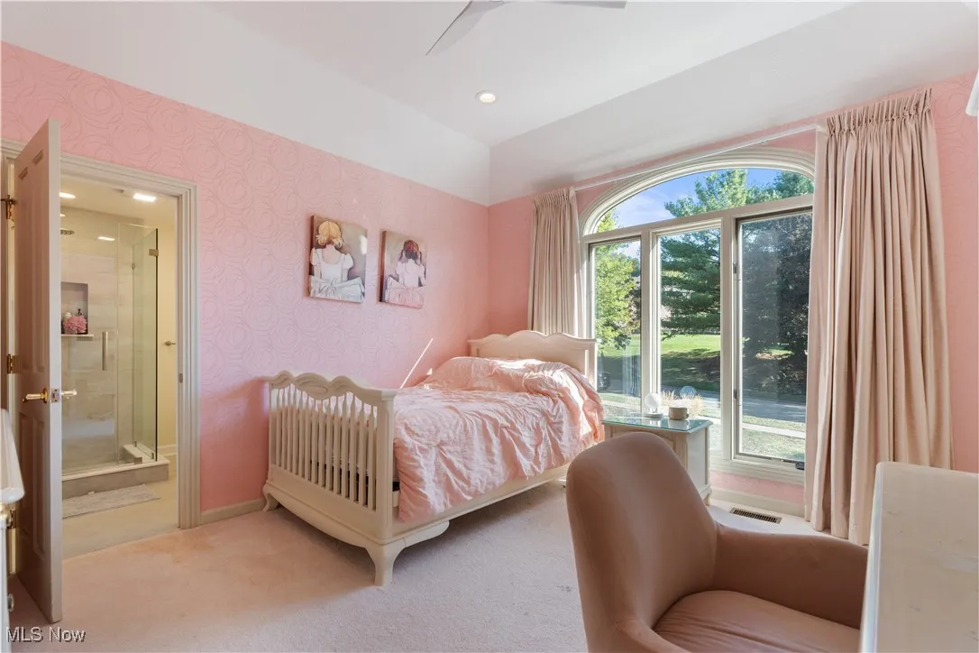 Bedroom 3 of 5 with an ensuite bathroom, recessed lighting, a large window and and a ceiling fan.